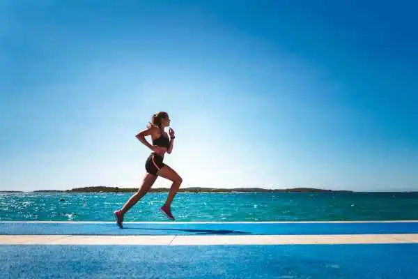 Woman running showing strong leg muscle Lancashire